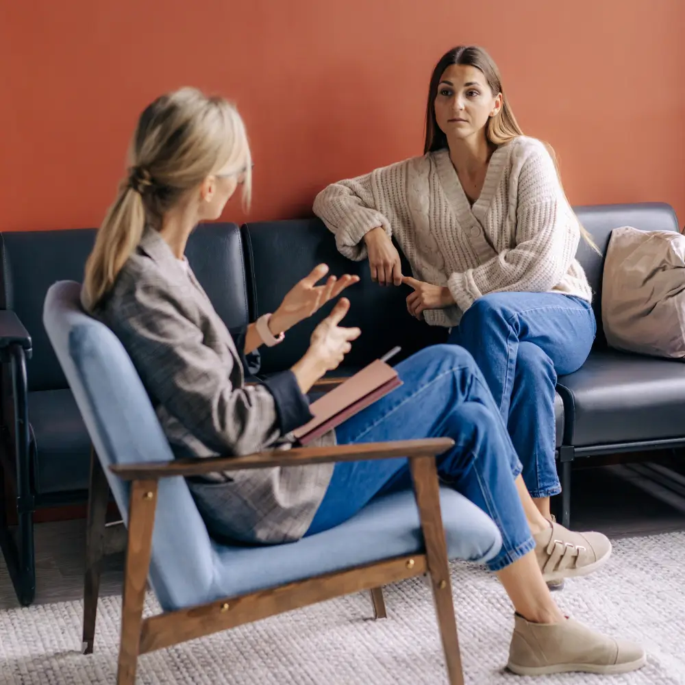 Therapist talking with two clients during a counselling session