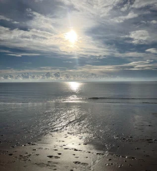 View_of_sea Calm sea and coastline viewed from the beach